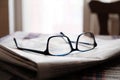Closeup shot of eyeglasses on the stack of newspapers - learning concept Royalty Free Stock Photo