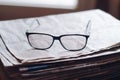 Closeup shot of eyeglasses on the stack of newspapers - learning concept Royalty Free Stock Photo