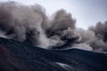 Closeup shot of the famous Etna volcano smoky and ashy top under a cloudy sky in Sicily, Italy Royalty Free Stock Photo