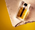 Closeup shot of a famous perfume bottle with a yellow background Royalty Free Stock Photo