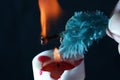 Closeup shot of a feather burning on a candlelight