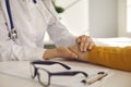 Closeup female doctor hold male patient hand give medical help support reassure