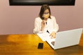 Closeup shot of a female doctor with medical face mask working with laptop at her desk Royalty Free Stock Photo