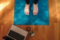 Closeup shot of female feet on yoga mat during an online class at home Royalty Free Stock Photo