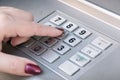 Closeup shot of a female finger pressings keys on an ATM machine keypad Royalty Free Stock Photo