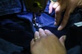 Closeup shot of female hands stitching a pocket of a jeans pants with sewing machine