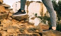 Closeup shot of a female hiking a rocky hillside