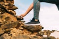 Closeup shot of a female hiking a rocky hillside