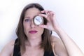 Closeup shot of a female holding a compass over the left eye Royalty Free Stock Photo