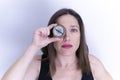 Closeup shot of a female holding a compass over the right eye Royalty Free Stock Photo