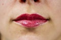 Closeup shot of female lips with light red lipstick