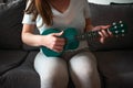 Closeup shot of a female playing a green ukulele Royalty Free Stock Photo