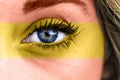 Closeup shot of a female's eye with the colors of the Spanish flag Royalty Free Stock Photo