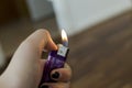 Closeup shot of a female's hand setting fire with the lighter Royalty Free Stock Photo