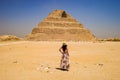 Closeup shot of a female standing in front of a Pyramid in Egypt