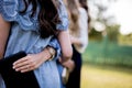 Closeup shot of female with their arms around each other while holding a bible Royalty Free Stock Photo