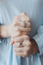 Closeup shot of a female wearing beautiful rings on both hands and showing with fists Royalty Free Stock Photo