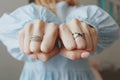 Closeup shot of a female wearing beautiful rings on both hands and showing with fists Royalty Free Stock Photo
