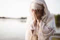 Closeup shot of a female wearing a biblical robe crying  - concept confessing sins Royalty Free Stock Photo
