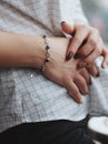 Closeup shot of a female wearing a fashionable silver charm bracelet