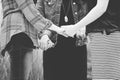 Closeup shot of females holding hands and praying in black and white Royalty Free Stock Photo