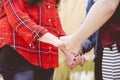 Closeup shot of females holding hands while praying with a blurred background Royalty Free Stock Photo