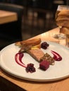 Closeup shot of a fish fillet on a beautifully decorated plate with two pieces of bread Royalty Free Stock Photo