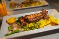 Grilled calmari plate, dinner at seafood restaurant in Greece. Exquisite food Royalty Free Stock Photo