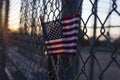 Closeup shot of the flag of the USA on a grid fence Royalty Free Stock Photo