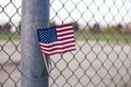 Closeup shot of the flag of the USA on a grid fence Royalty Free Stock Photo