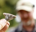 Closeup shot of a flint tool in the background of the finder