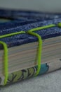 Closeup shot of folded paper sheets bound with green thread Royalty Free Stock Photo