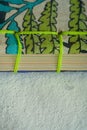Closeup shot of folded paper sheets bound with green thread Royalty Free Stock Photo