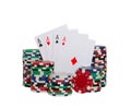 Closeup shot of four aces playing cards and a stack of poker chips isolated on white background