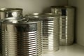 Closeup shot of four metal tins in the shelf