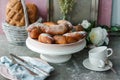 Closeup shot of fresh baked buns with black sesame and sugar powder on a white plate Royalty Free Stock Photo