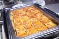 Closeup shot of a fresh lasagna in a steel tray