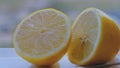 Closeup shot of a fresh lemon separated into two pieces - perfect for a recipe article