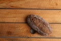 Closeup shot of freshly-baked homemade artisanal brown bread with nuts on a wooden surface Royalty Free Stock Photo