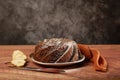 Closeup shot of freshly-baked pear bundt cake with pear on wooden table Royalty Free Stock Photo