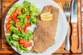 Closeup shot of fried veal cutlet Milanese with lemon and salad Royalty Free Stock Photo