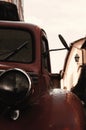 Closeup shot of a front half view of a red retro car on a rainy day Royalty Free Stock Photo