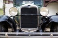 Closeup shot of the front part of an old car with round headlights Royalty Free Stock Photo