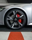 Closeup shot of the front wheel of Audi RS6 in matte silver at the parking lot