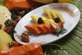 Closeup shot of fruit cocktail with pineapple, papaya, melon, strawberry, and blackberry