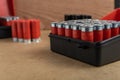 Closeup shot of a full shotgun ammo box on a brown surface