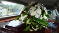 Closeup shot of a funeral casket in a hearse or chapel or burial at cemetery