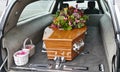 Closeup shot of a funeral casket in a hearse or chapel or burial at cemetery Royalty Free Stock Photo
