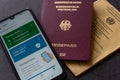 Closeup shot of a german digital green pass near a german passport and vaccination card Royalty Free Stock Photo