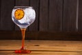 Closeup shot of Gintonic with orange on a wooden table Royalty Free Stock Photo